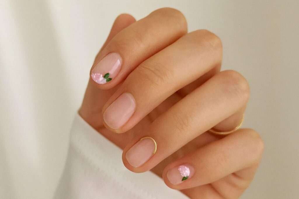 French manicure with tiny hand-painted peonies and gold accessories, pastel princess cake style