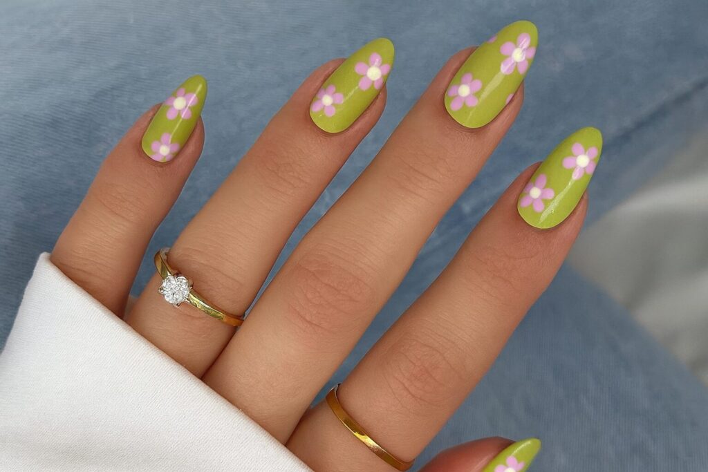 Green French manicure with pink daisy nail art for a Scandinavian summer vibe.