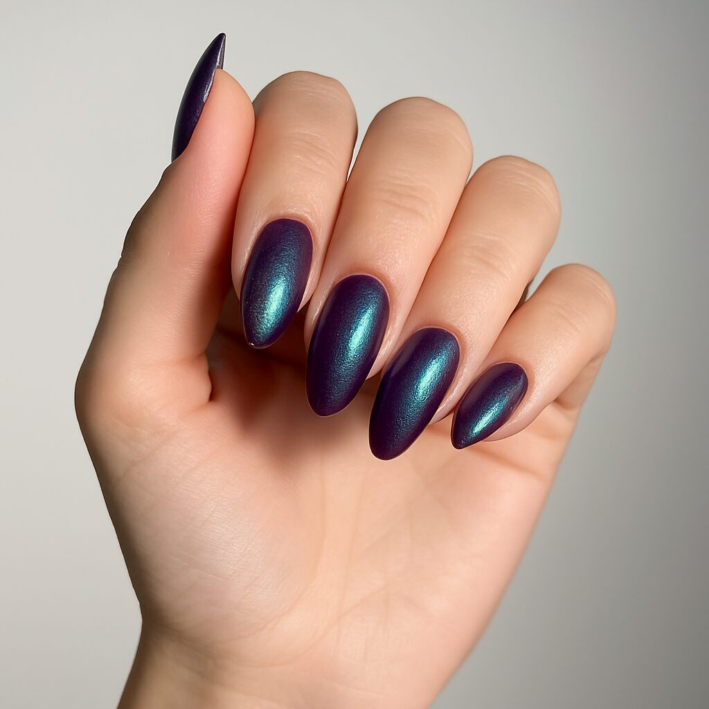 Holographic eggplant nails shifting between purple and deep blue.