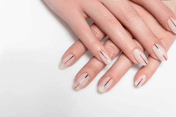 minimalist white flourishes on nude nails, chic old money manicure close-up