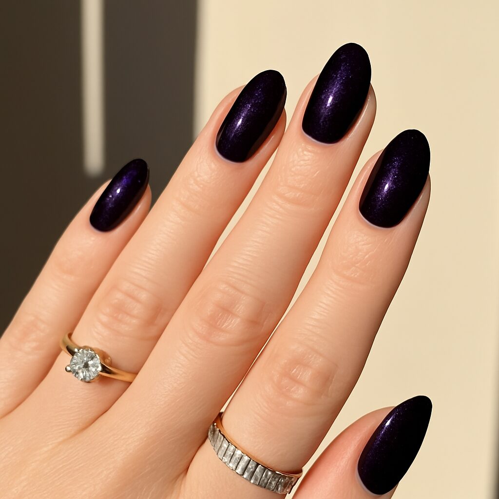 Short dark eggplant nails with moody vampy purple polish.