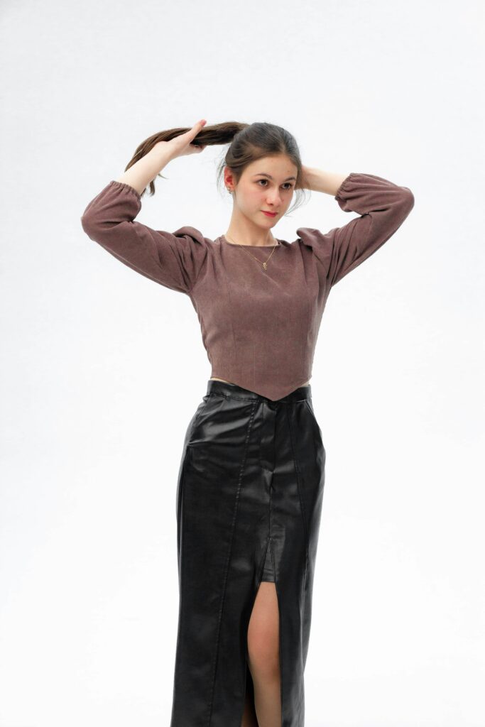 black leather skirt with cream turtleneck sweater and boots, office outfit idea