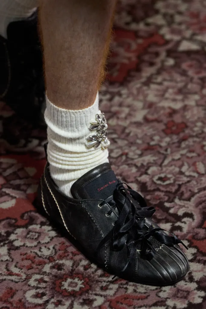 Hybrid sneaker-ballet flats with satin details and ribbons, sneakerina trend fall 2025.