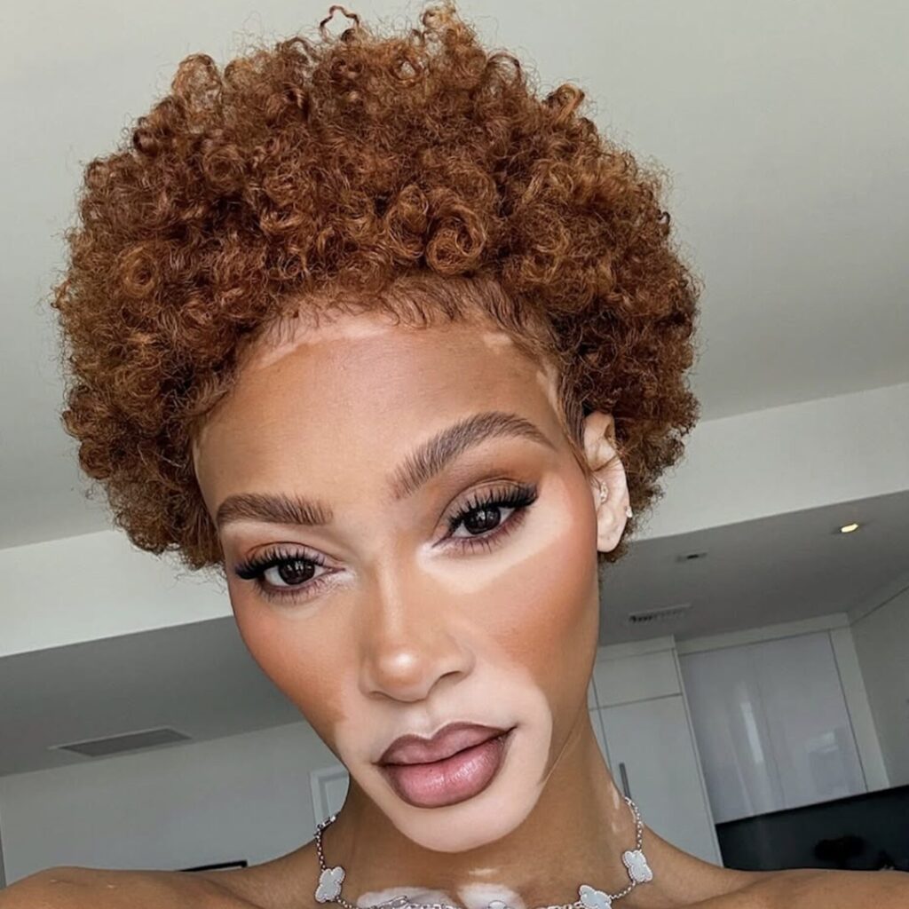 Warm beige and honey blonde blend styled in loose waves