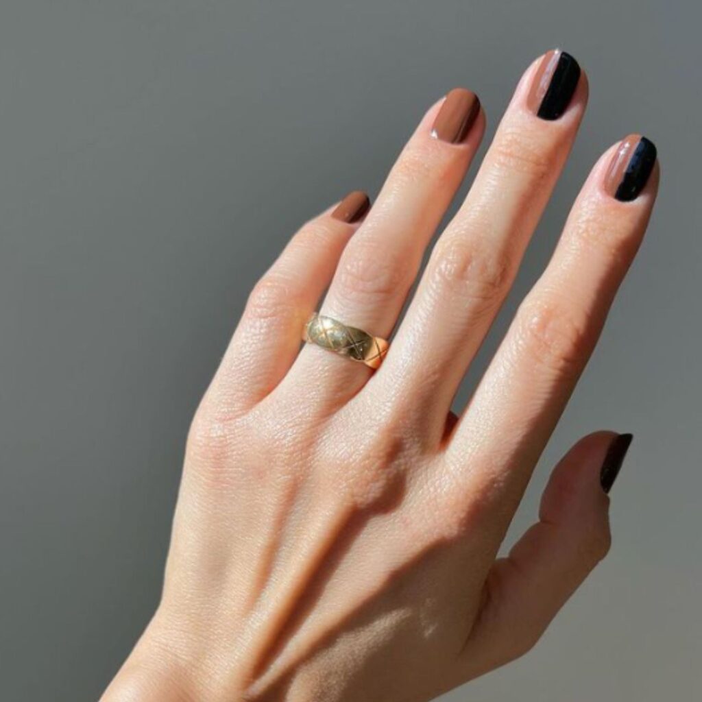 Swirled coffee-inspired nail design blending cream and mocha tones in an elegant, abstract pattern.