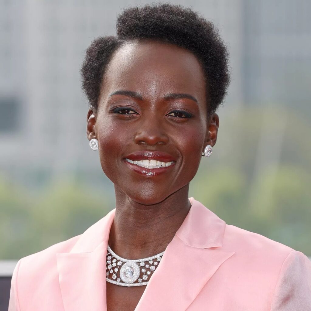 Lupita Nyong’o with elegant box cut hairstyle featuring coily parted short natural hair