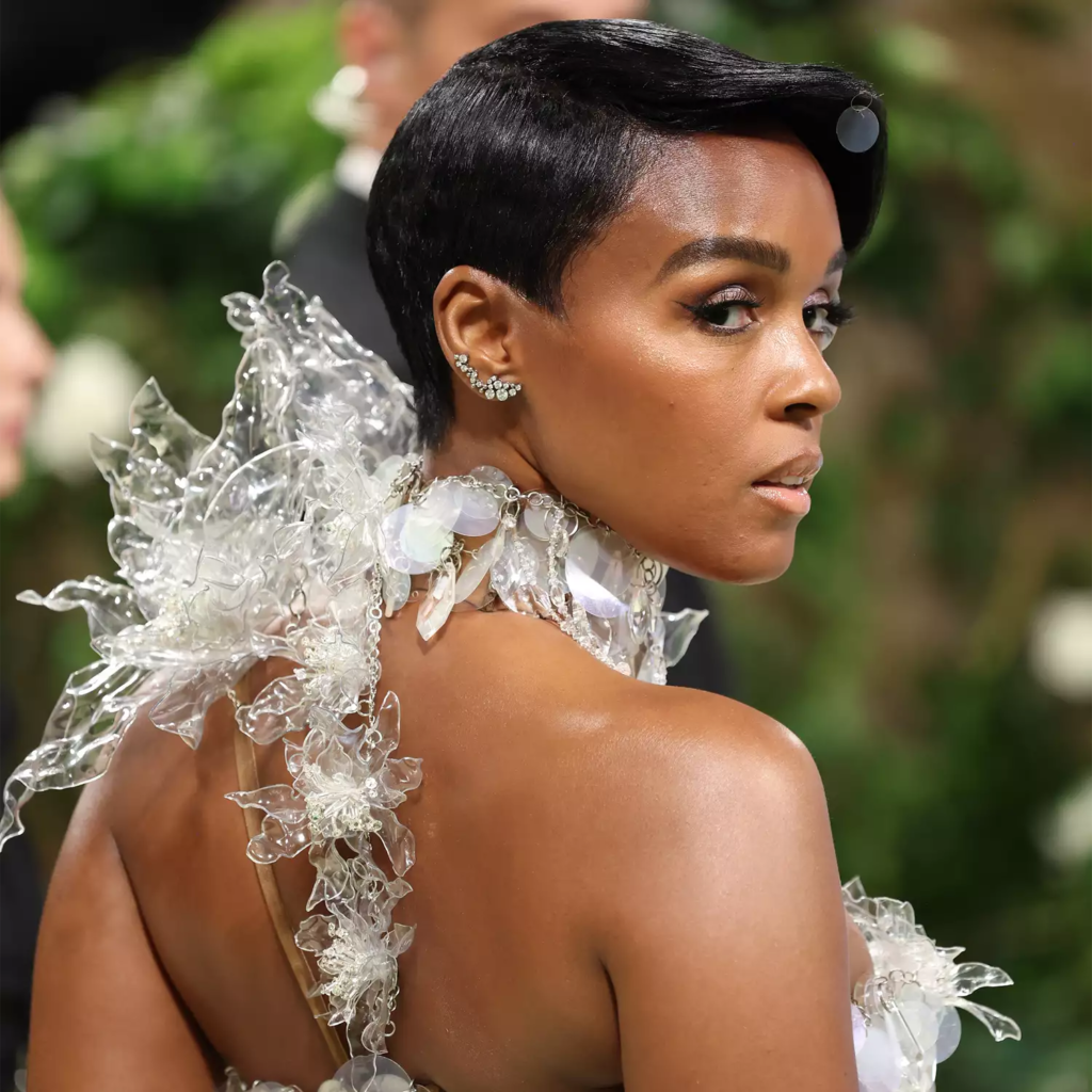 Janelle Monae wearing artistic sculpted pixie cut with side part and floating bang