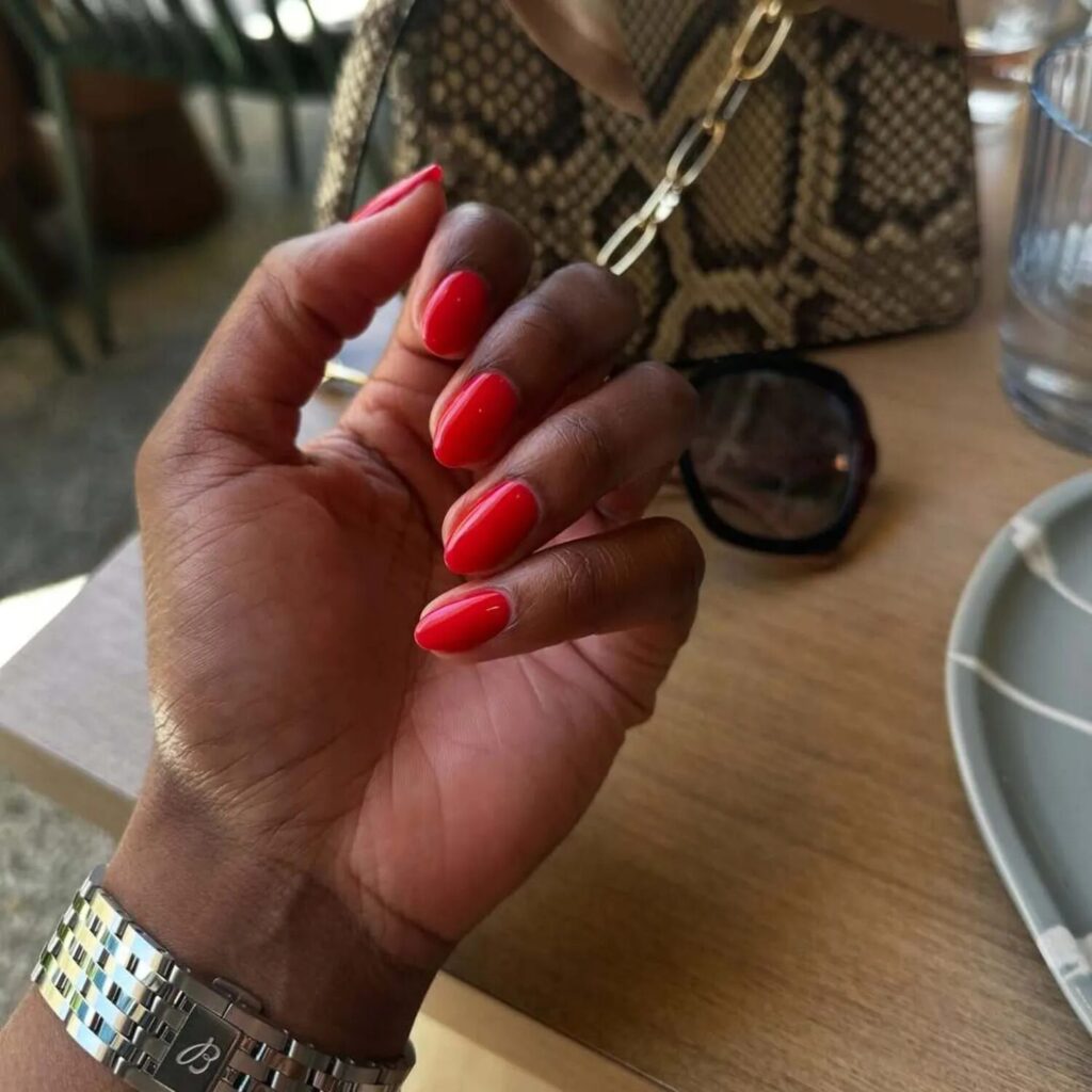 Short crimson red manicure on neatly shaped nails bold and sophisticated nail idea