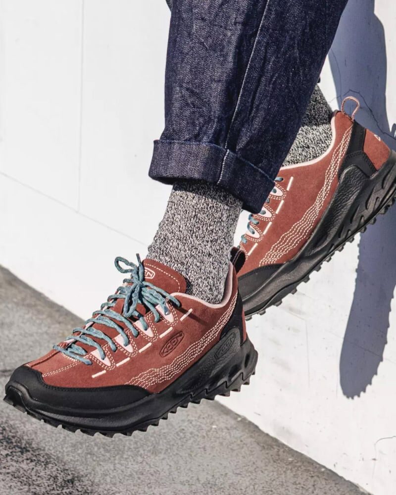 close-up of hiking sneakers styled with black cargo pants and outdoor jacket