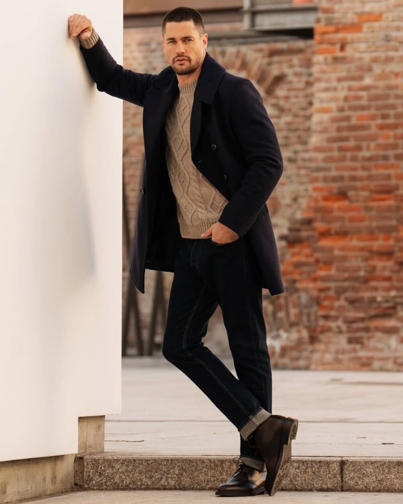 man wearing brown suede chukka boots with navy chinos and casual shirt