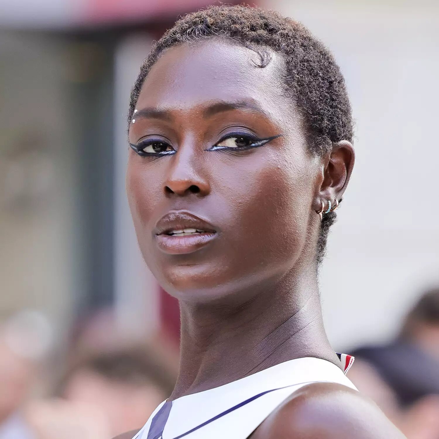 Jodie Turner-Smith wearing classic TWA teeny weeny afro styled with conditioned coils and edge swoop