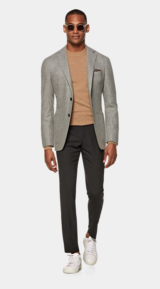 man wearing sandy overshirt with chinos and cream sneakers in casual office
