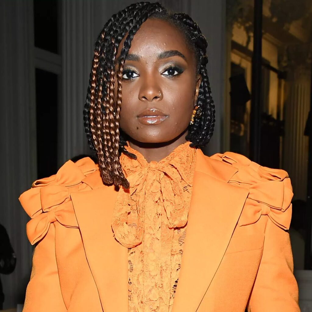 Kiki Layne with creative braided bob hairstyle styled asymmetrical with two tone braids