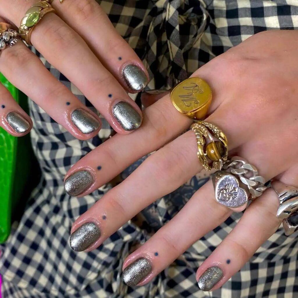 Short pewter chrome nails with metallic accents high fashion heavy metal manicure