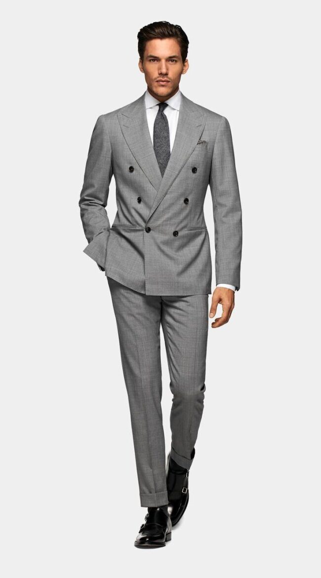 man wearing graphite double-breasted suit with black shirt and oxfords
