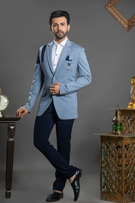 man in storm blue blazer with lavender shirt and slim trousers