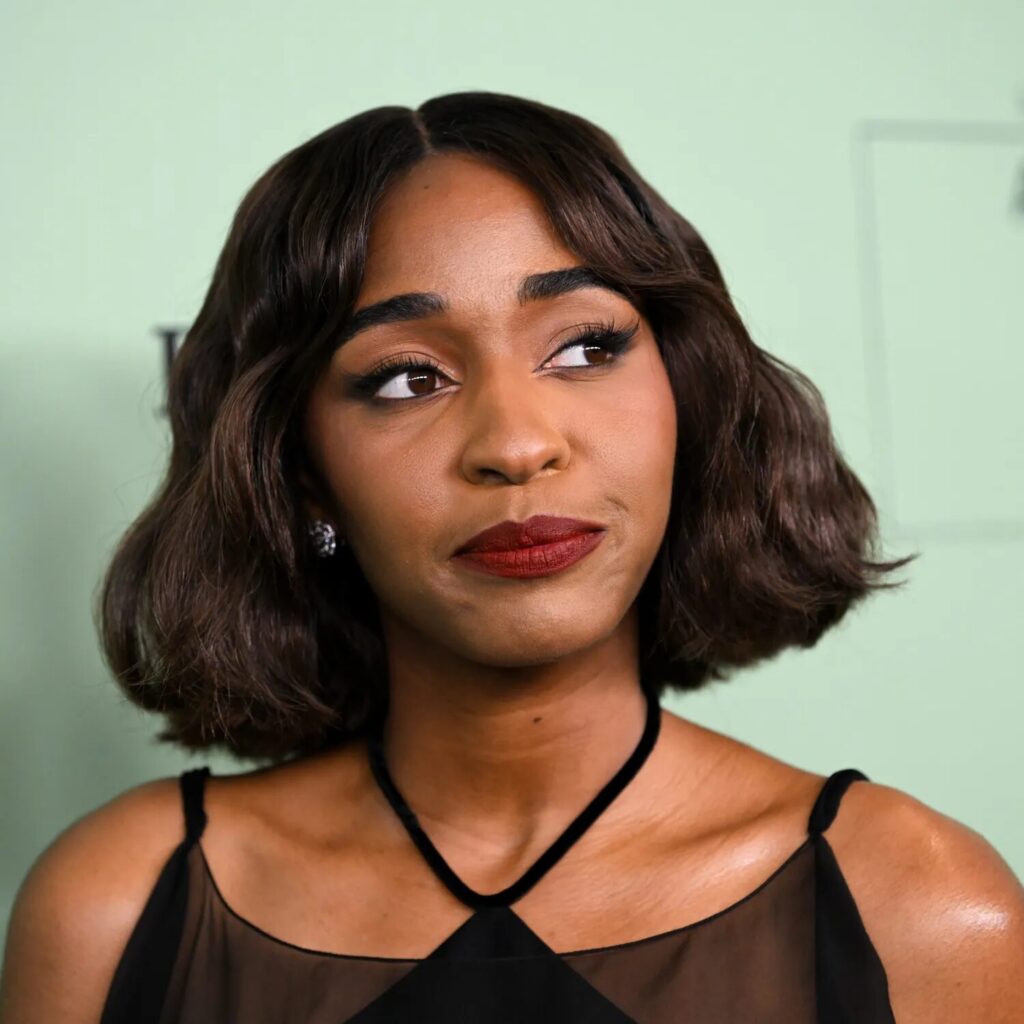 Ayo Edebiri with sleek wavy short bob hairstyle styled with a soft side part