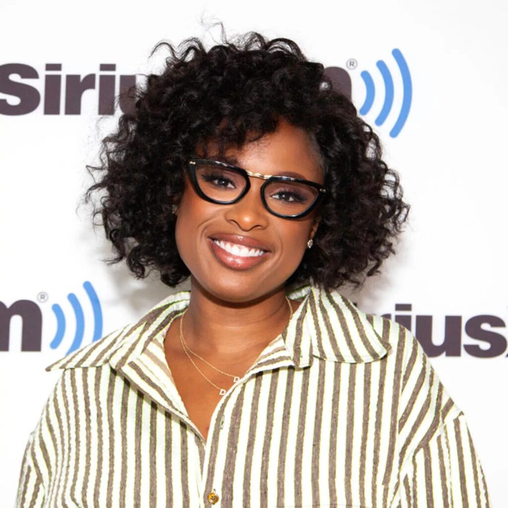 Jennifer Hudson with short fluffy wand curls styled into a voluminous side part afro