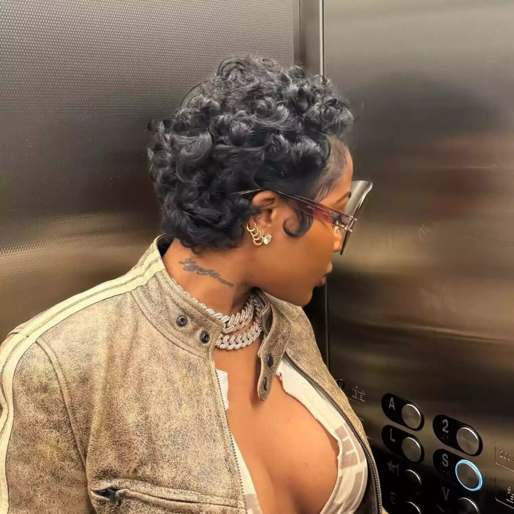 Jayda Cheaves showing fluffy pixie cut with tiny curls created by flat iron