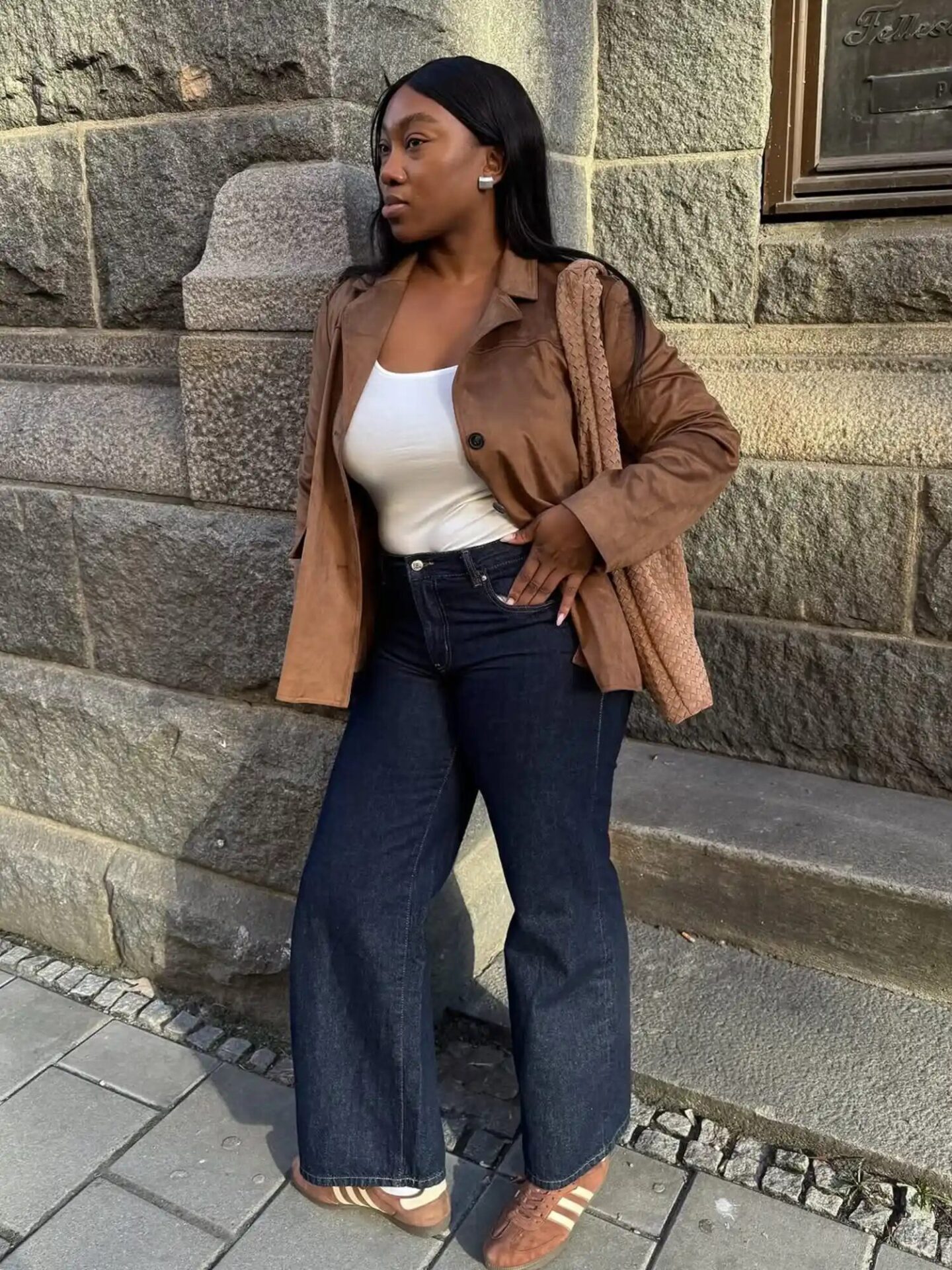 Classic fall outfit with straight-leg denim, white tee, and colorful sneakers.