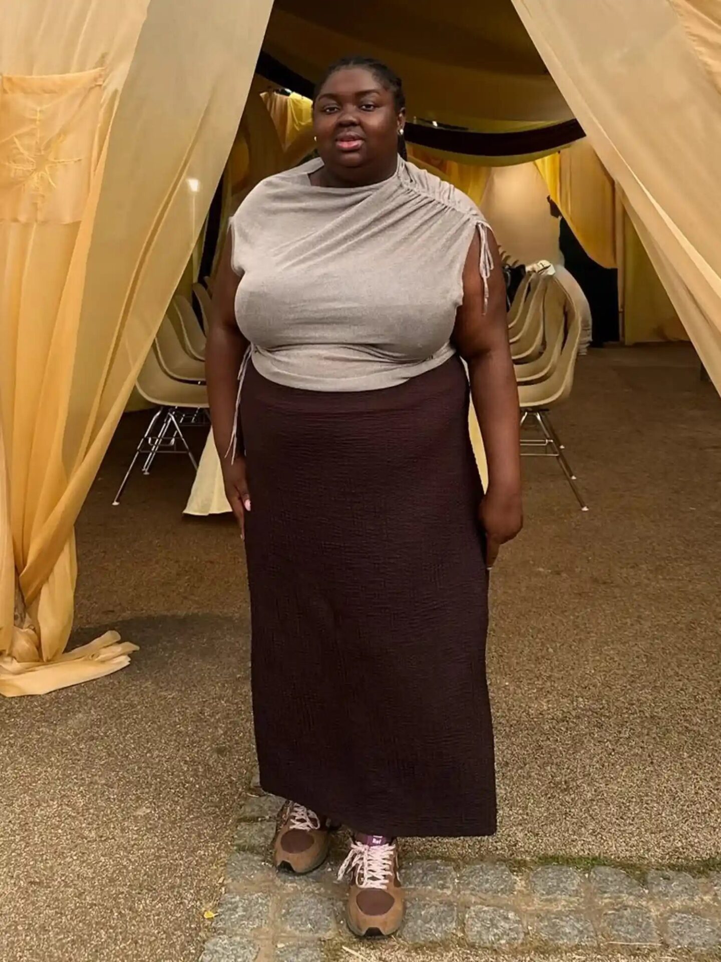 Feminine maxi dress paired with sneakers and cozy fall layers.