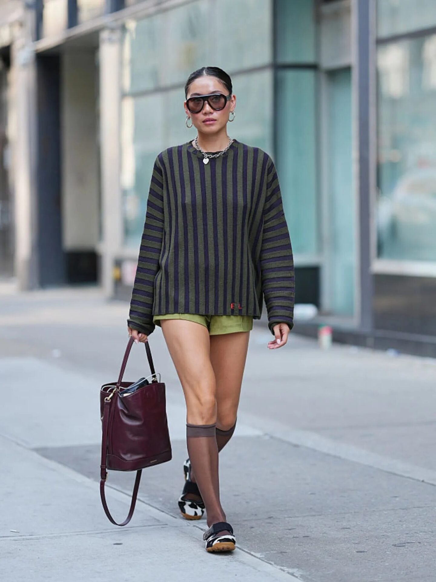 Chic fall look inspired by Princess Diana with an oversized sweater and shorts.