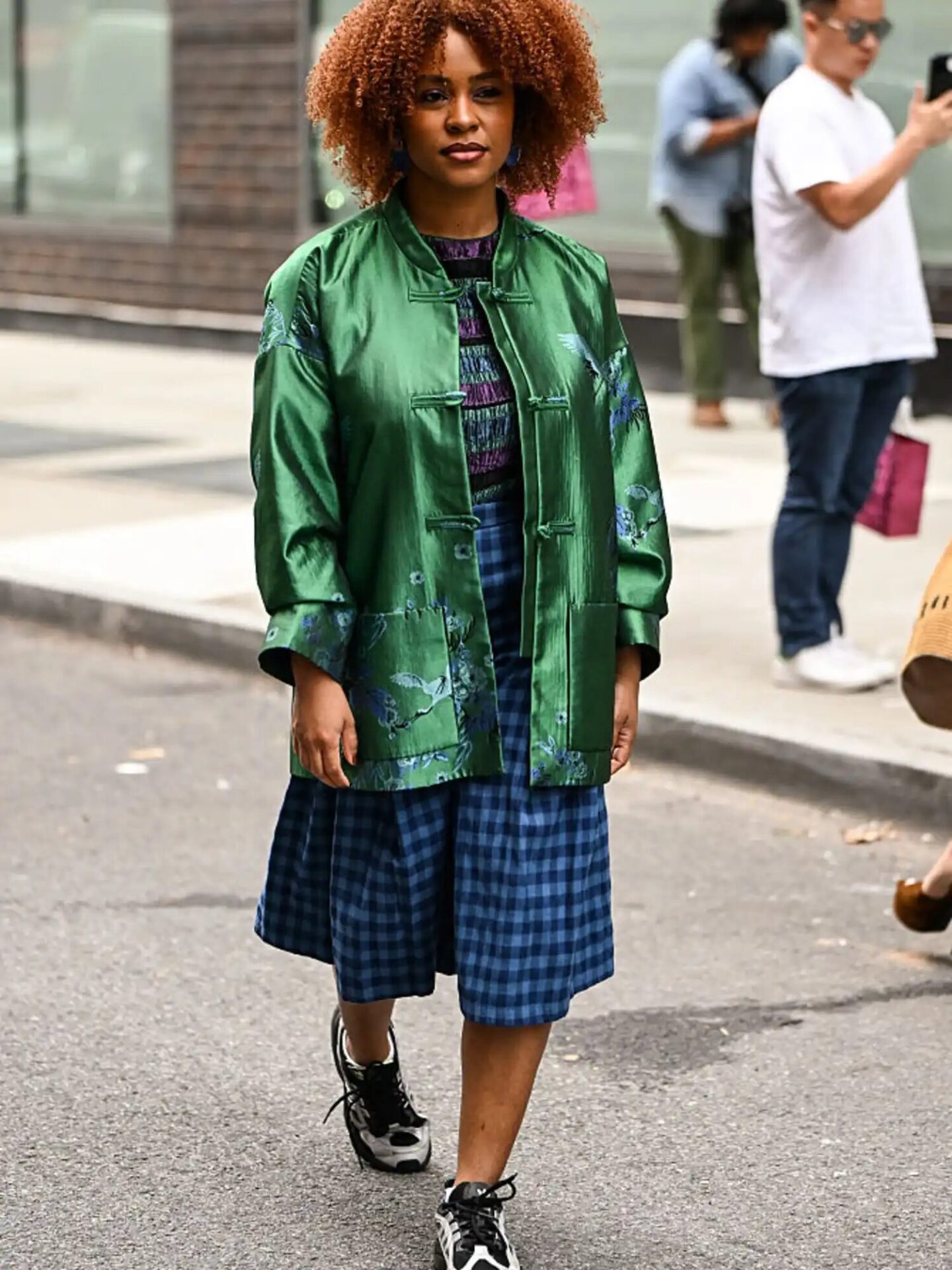 Glam-meets-casual outfit mixing sequins, silk, and sneakers for a day-to-night look.