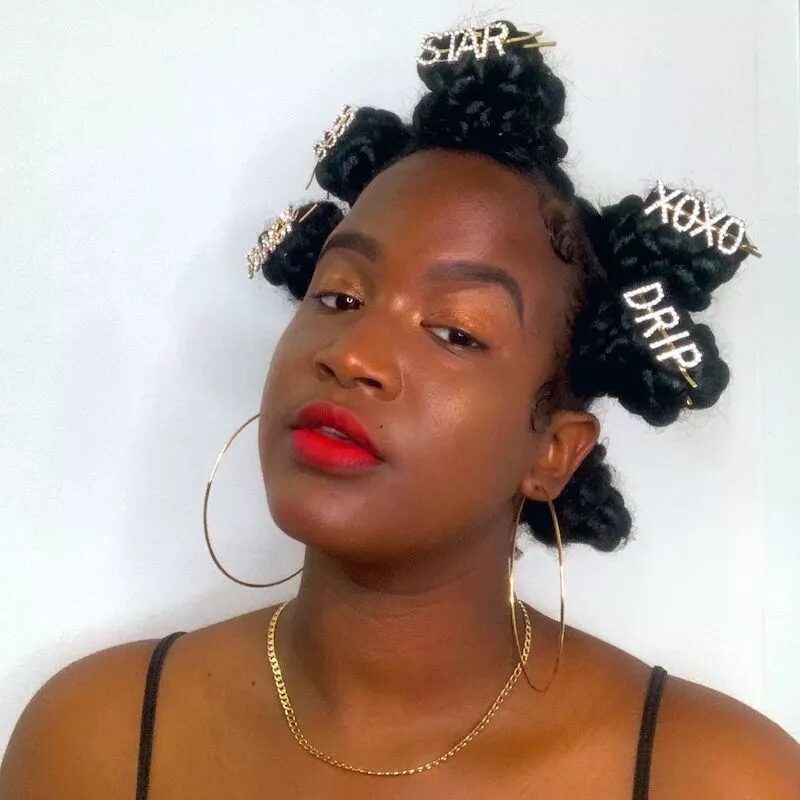 Woman with large Bantu knots creating a full crown style and voluminous fall hair look