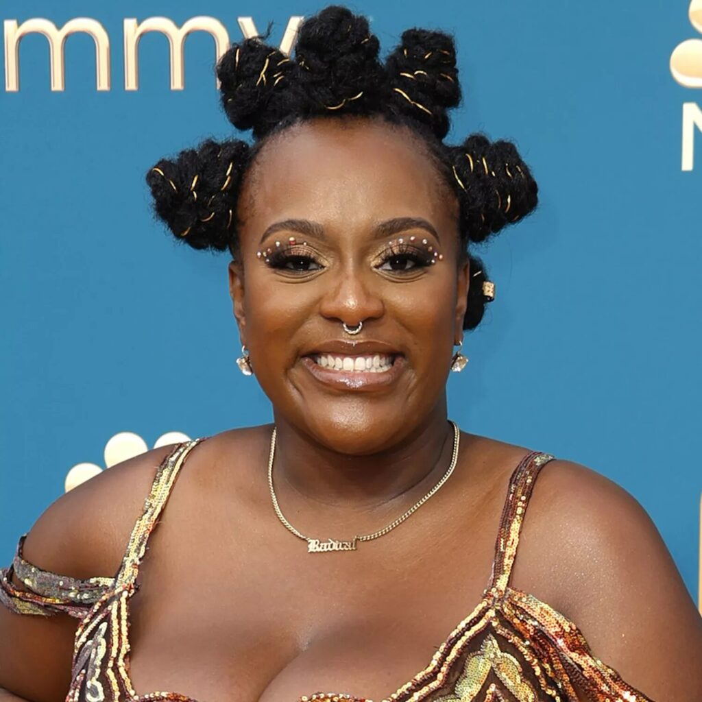 Model with gold wrapped Bantu knots showing metallic wire details and elegant shine