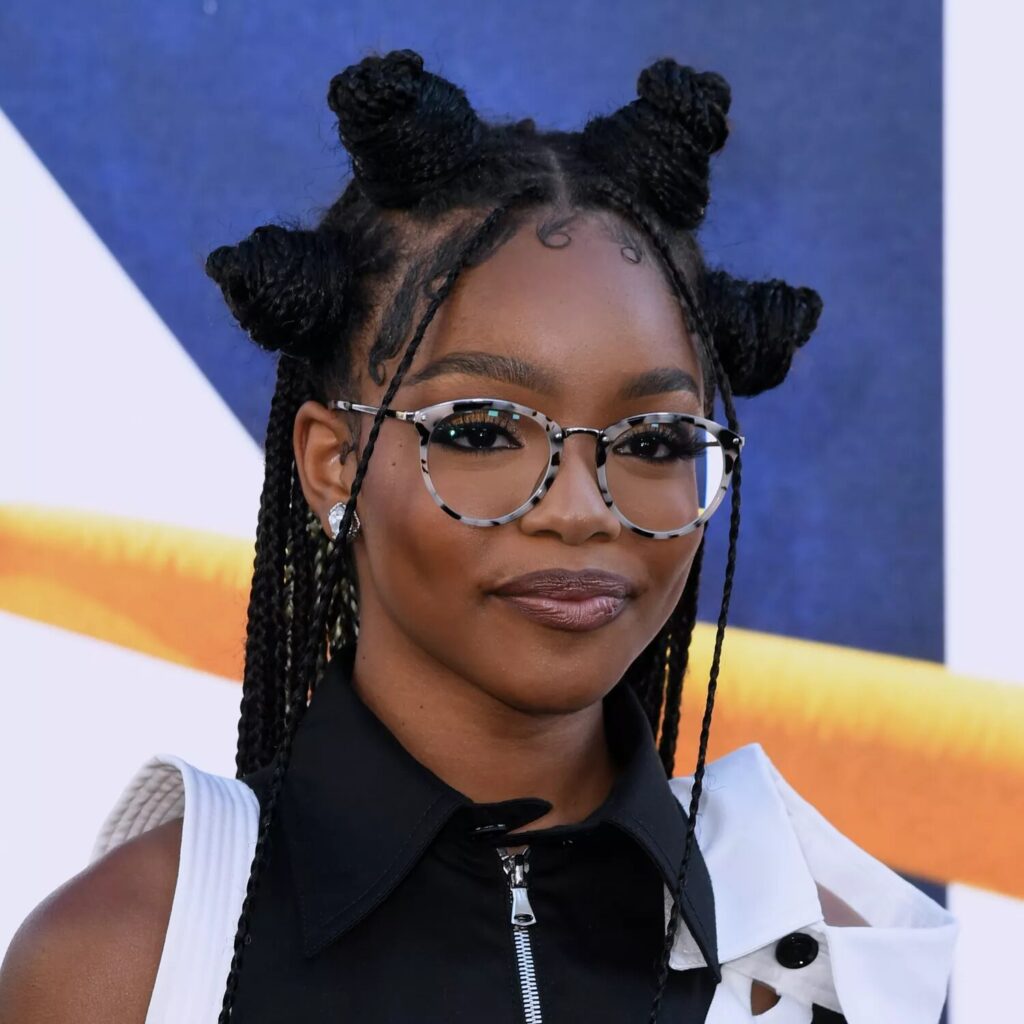 Young woman with sleek Bantu knots and swooped baby hairs wearing soft glam makeup