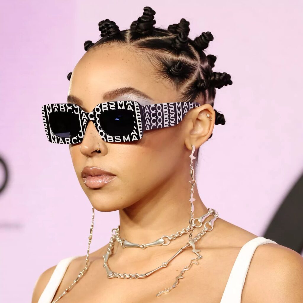 Top view of Bantu knot hairstyle with star shaped parts and small triangle sectioning