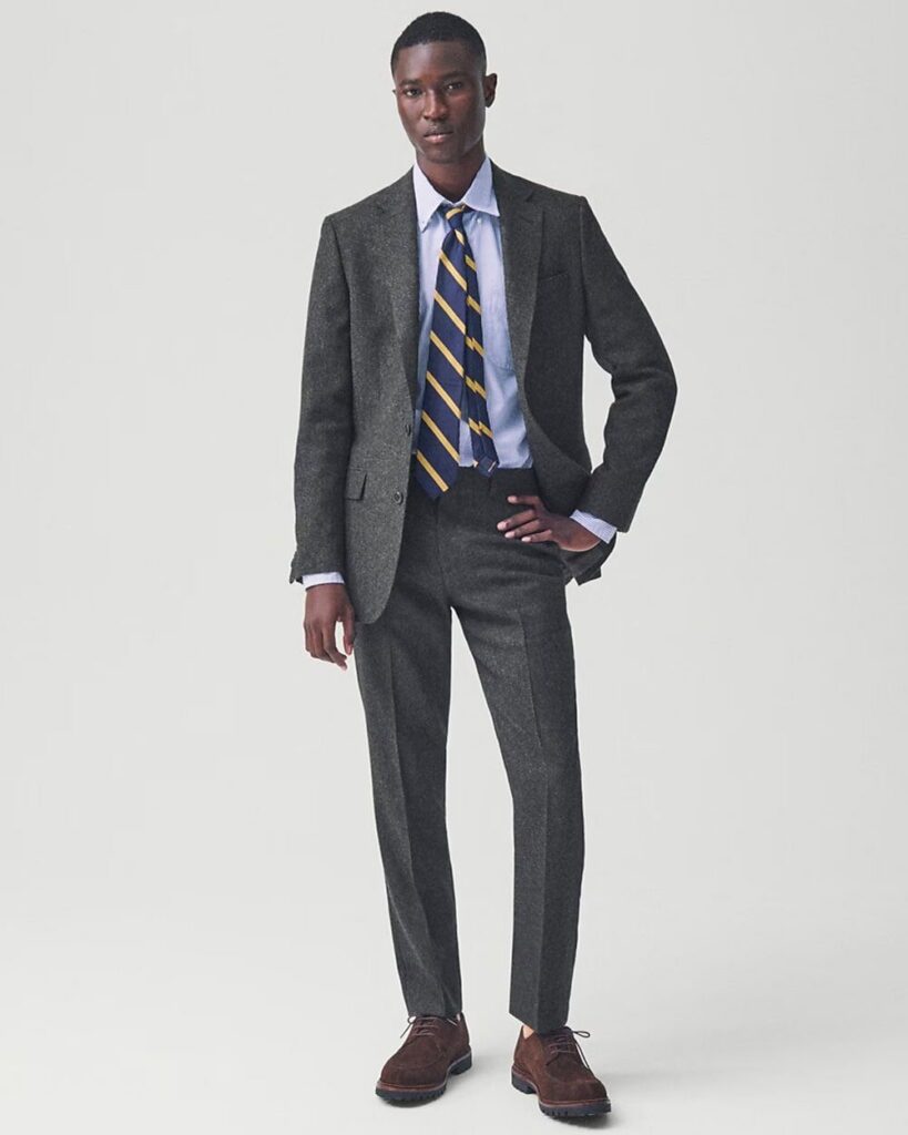 Model in J.Crew Ludlow slim fit suit made from Italian wool, styled with brown shoes and minimalist accessories.
