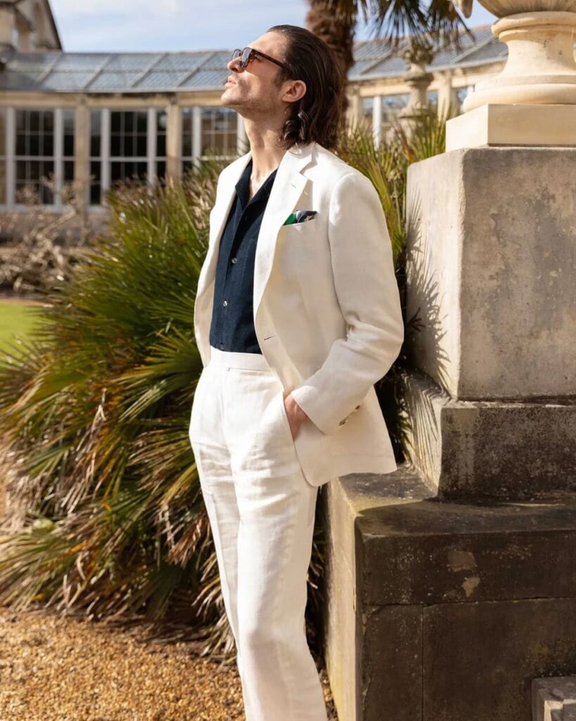 Model wearing Richard James Hyde fit wool suit in charcoal with tie, highlighting Savile Row craftsmanship.