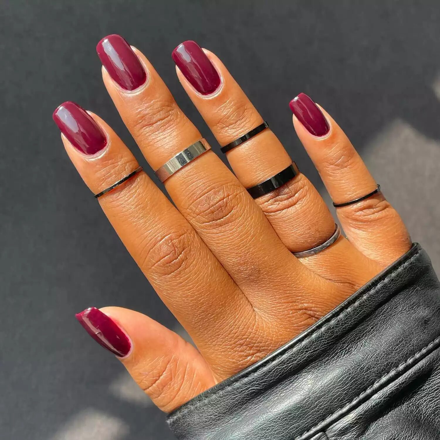 Close-up of classic burgundy nails painted with glossy deep red polish for a timeless fall manicure