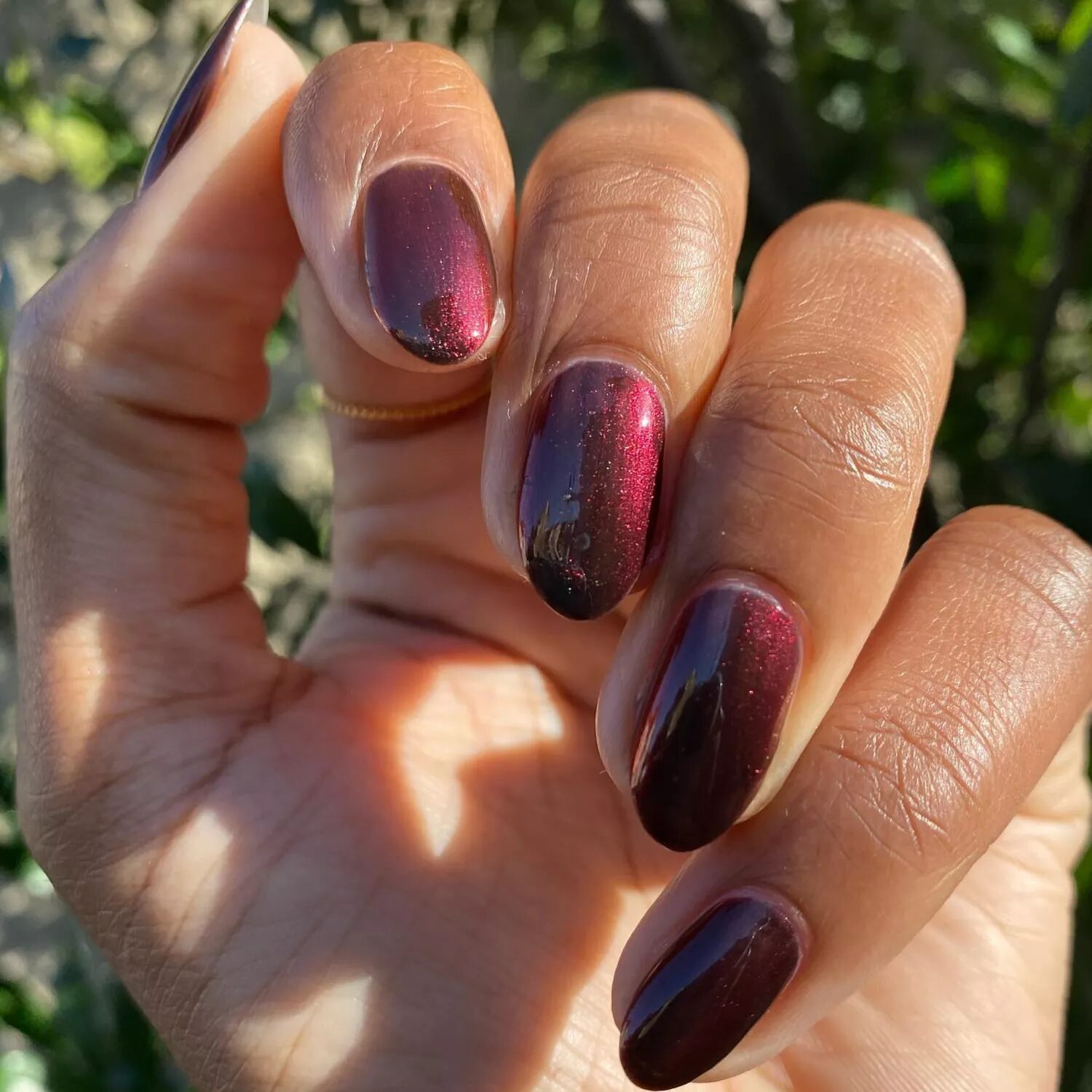 Burgundy nails featuring dainty bow nail art and mix-and-match coquette-inspired designs.
