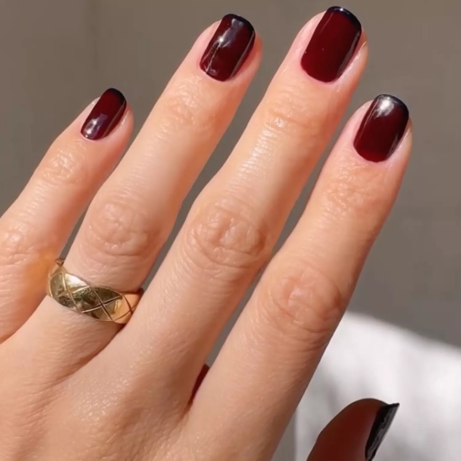 Burgundy and navy two-tone nails with French tip accents for a bold and creative fall manicure.
