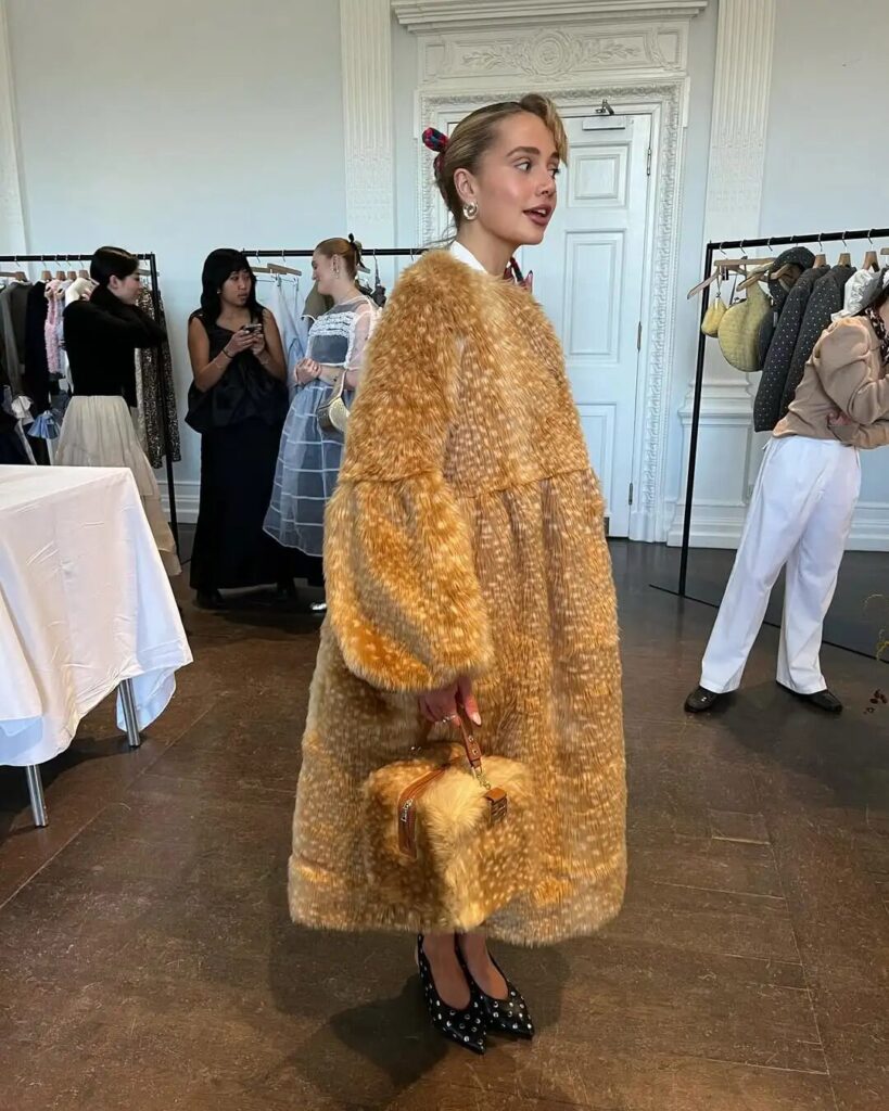 Model wearing Sandy Liang fawn-print fleece and Sofia Richie Grainge wool jacket in fall look.