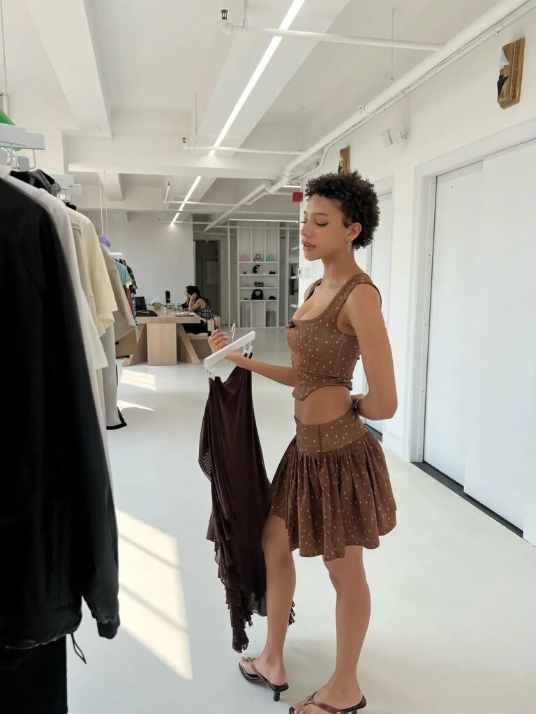 Model wearing Sandy Liang fawn-print fleece and Sofia Richie Grainge wool jacket in fall look.