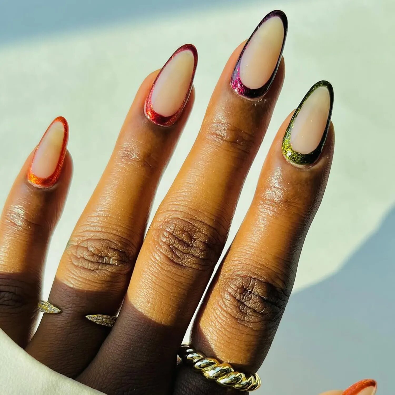 Minimal milky nails outlined with soft chrome edges in fall tones