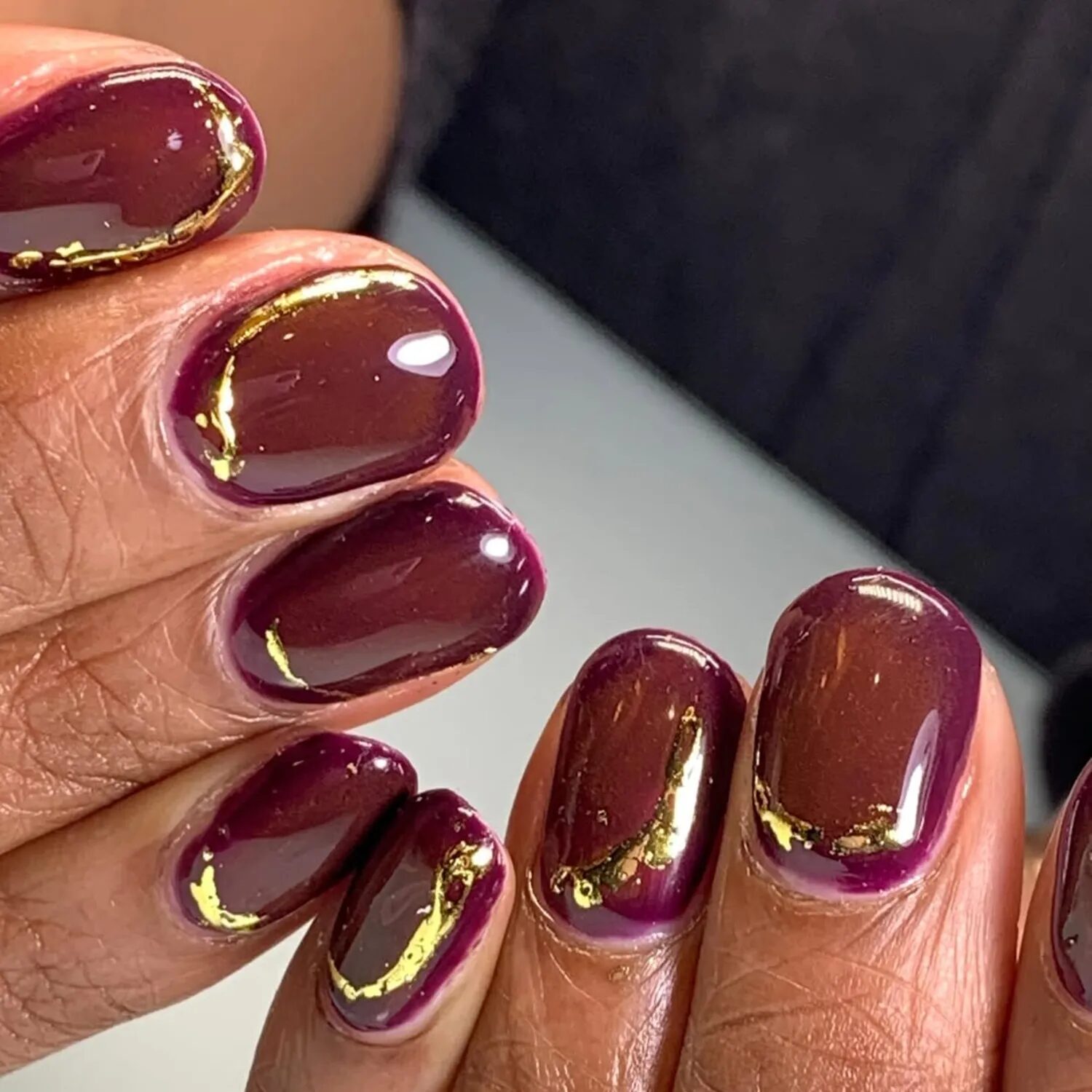Berry-to-wine ombré nails with glossy chrome shimmer