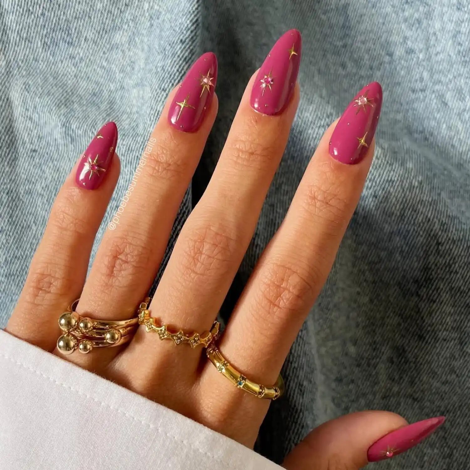 Mauve nails with golden celestial starburst accents