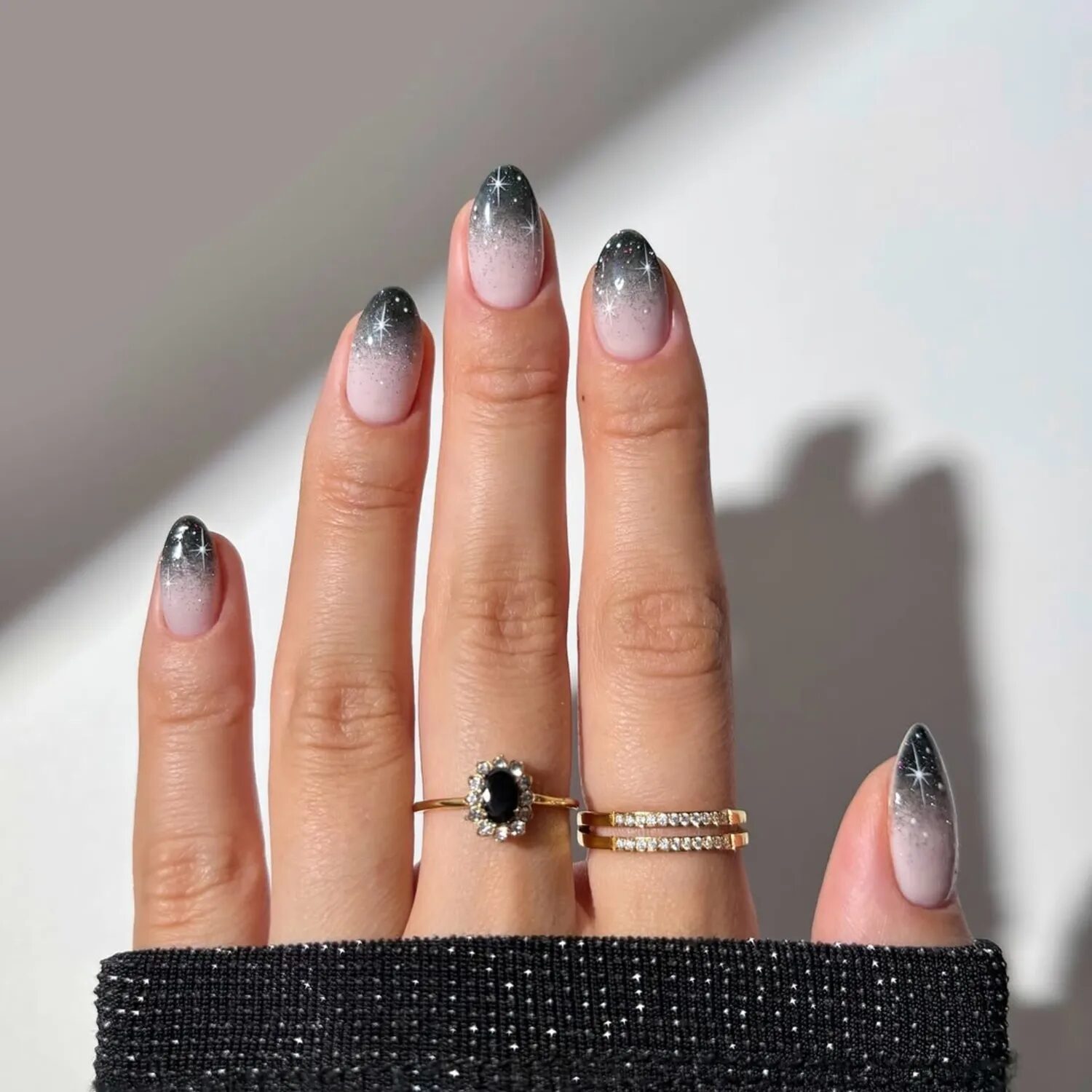Black-to-clear ombré chrome nails with holographic shimmer