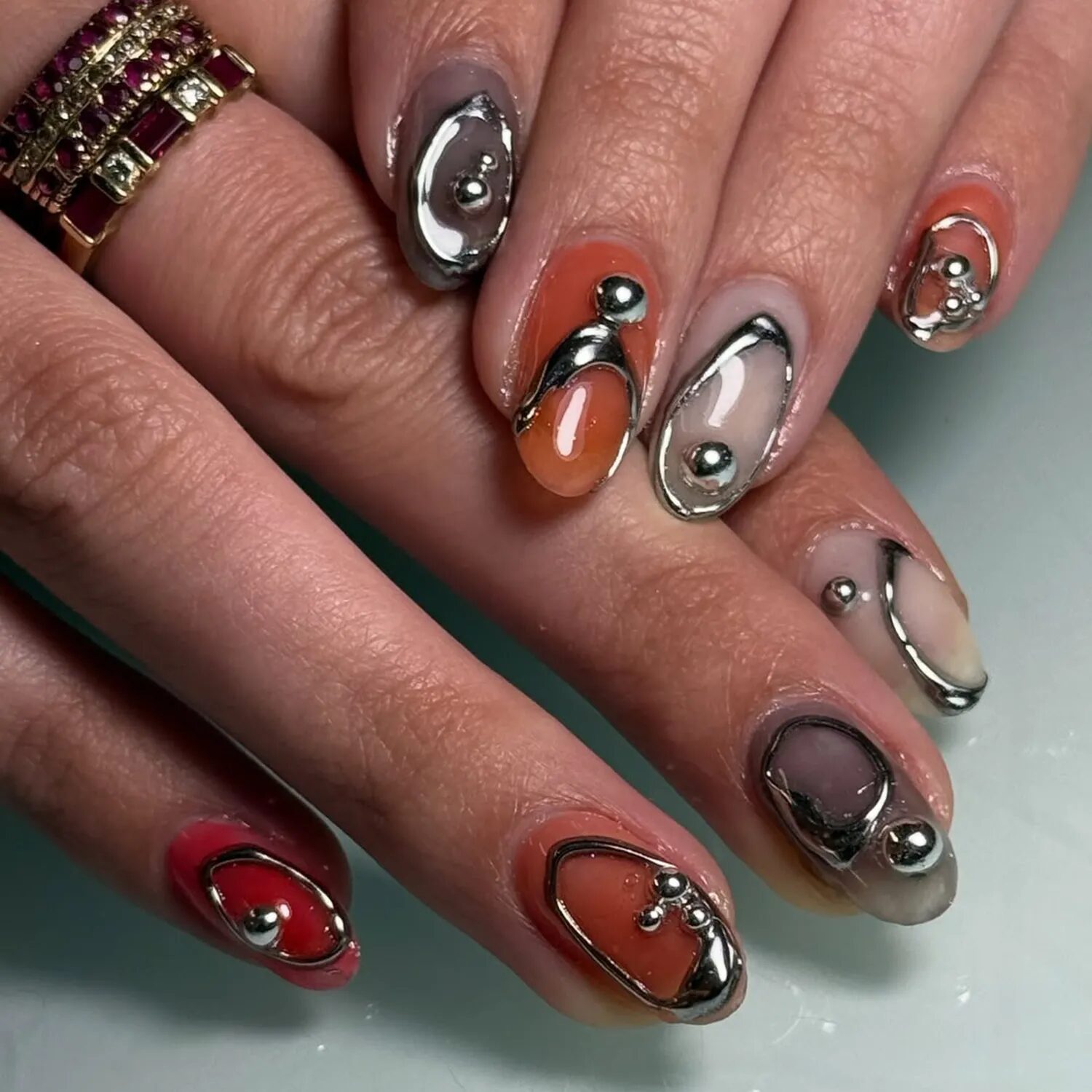 Abstract silver chrome leaf nail art on neutral base