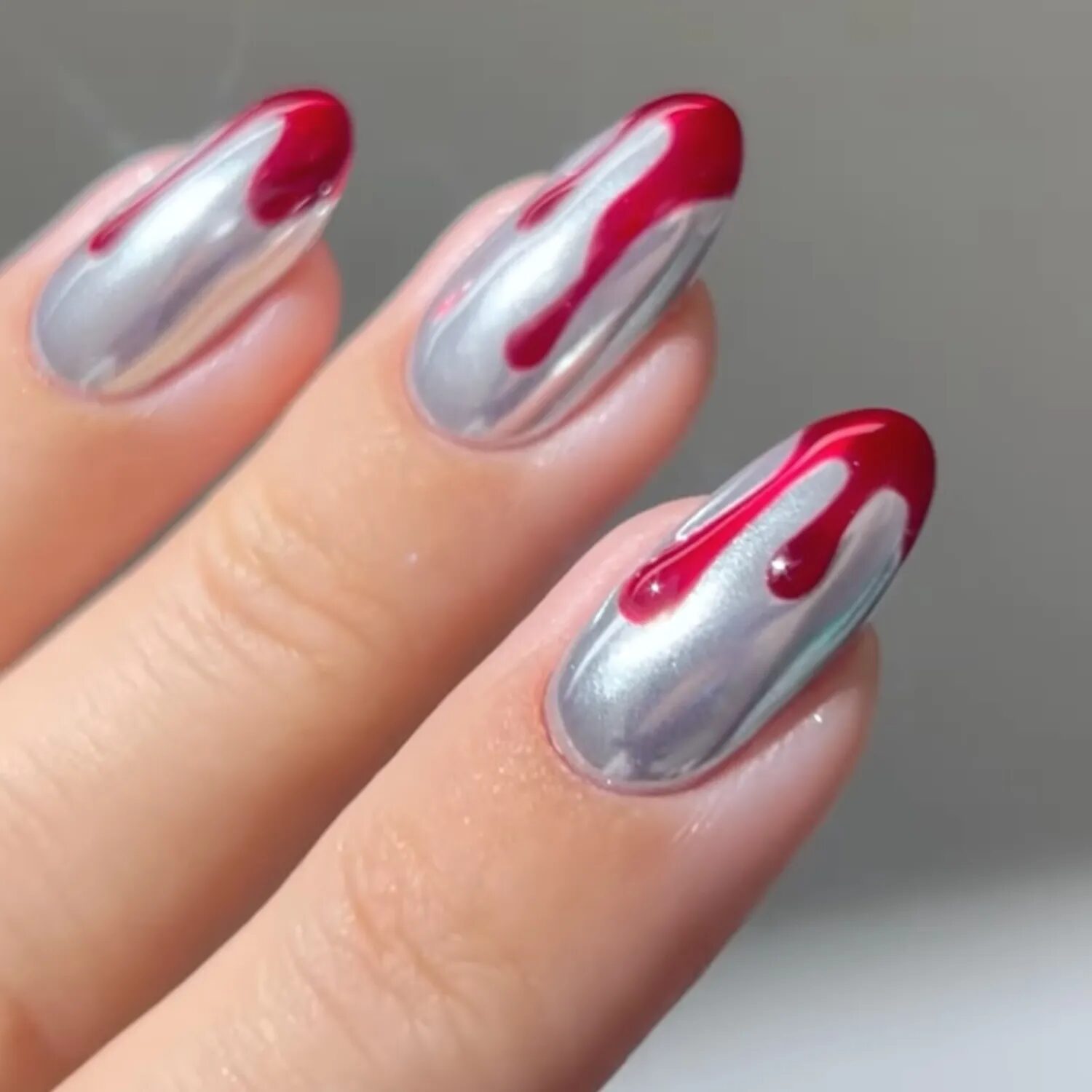 Silver chrome nails with 3D red drip accents for Halloween