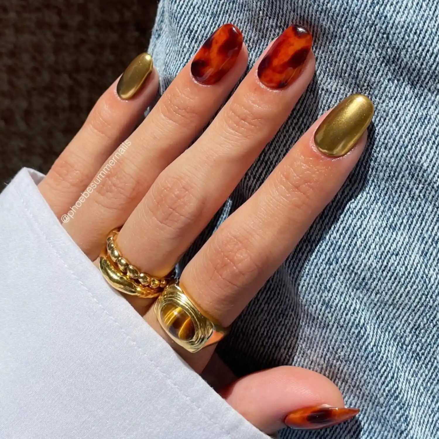 Tortoiseshell nails with subtle gold chrome tips