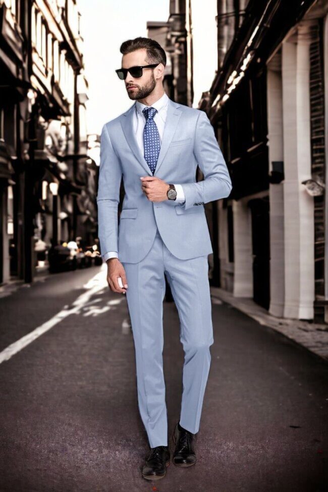 man in navy pinstripe suit with ice blue shirt and black dress shoes