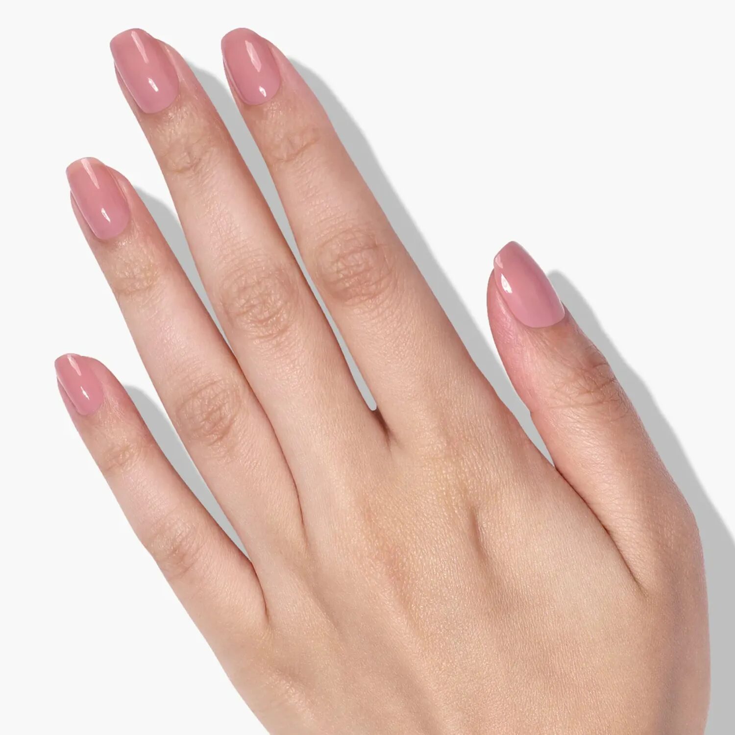 Elegant nails painted in rosy beige muted mauve shade with a soft finish