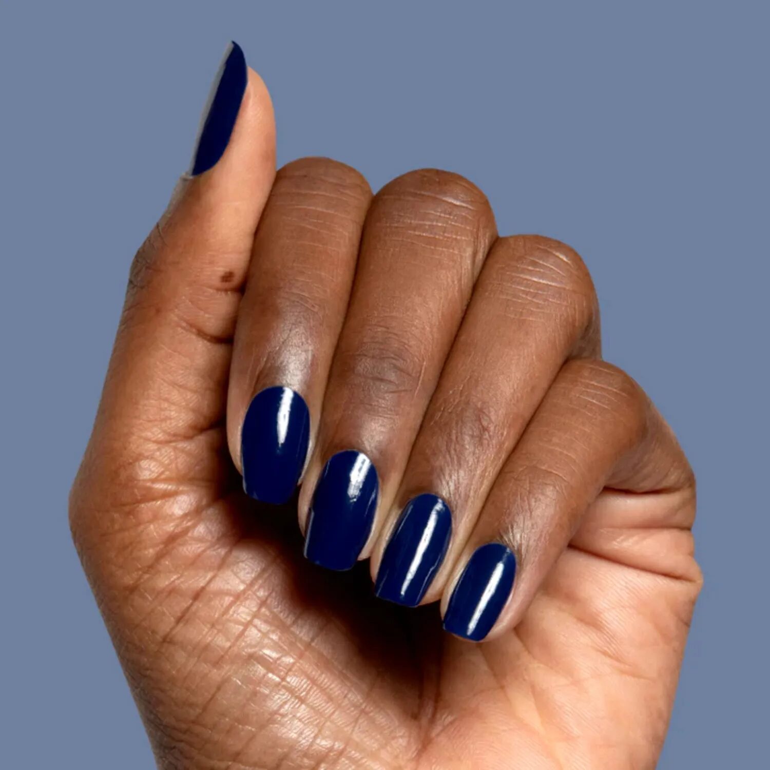 Classic short manicure in deep navy blue with a sleek tailored finish