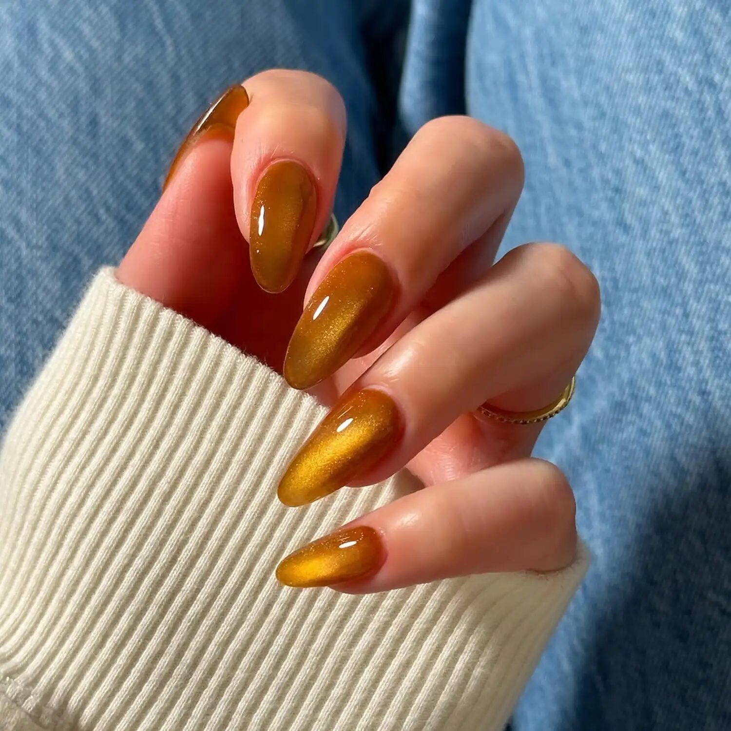 Amber velvet nails with glossy top coat and warm cozy autumn polish for fall 2025.