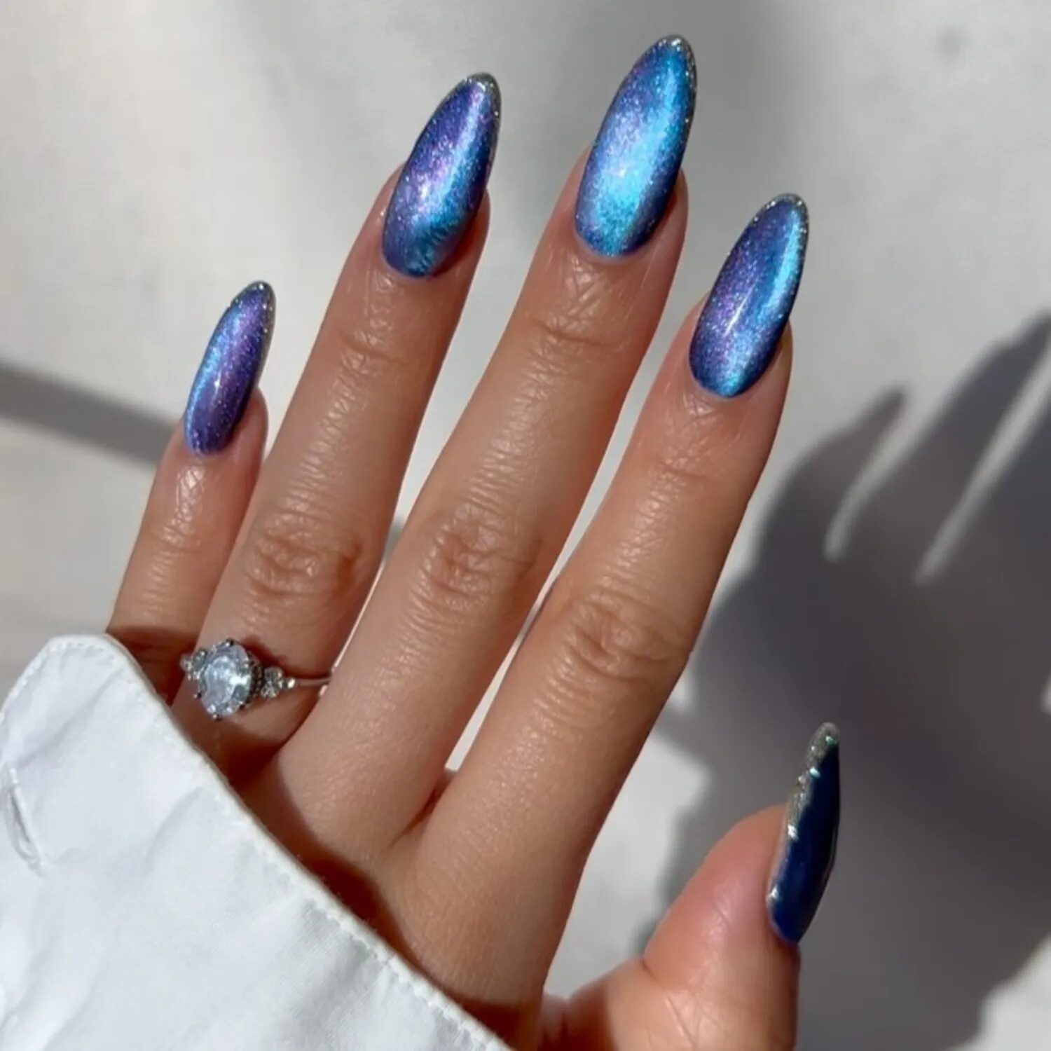 Shade-shifting navy and cerulean blue velvet nails inspired by midnight sky tones.